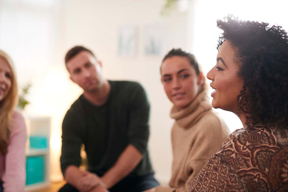 A woman speaking to a group of people